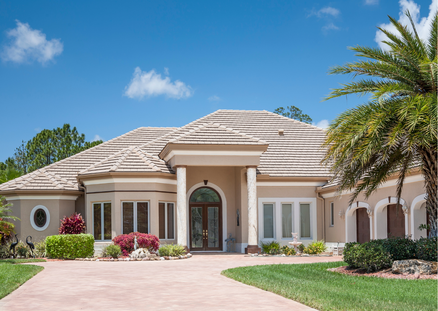 Luxury home exterior with landscaped front yard and driveway