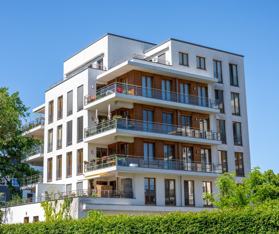 Modern apartment building with balconies and landscaped grounds